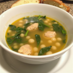 Soulful Chicken Soup with tender chicken, white beans, and fresh spinach in a light broth