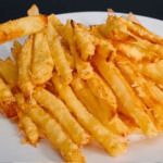 Homemade baked Parmesan potato fries served on a white plate