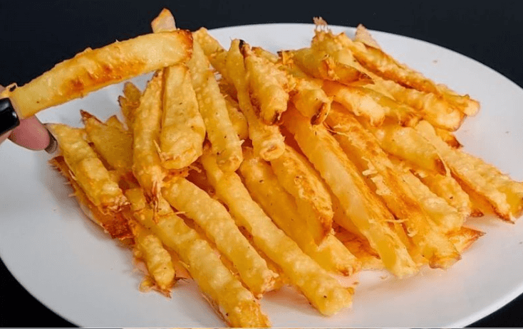 Homemade baked Parmesan potato fries served on a white plate