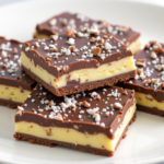 Delicious Heavenly Squares dessert bars with chocolate topping, creamy butter layer, and crunchy base.